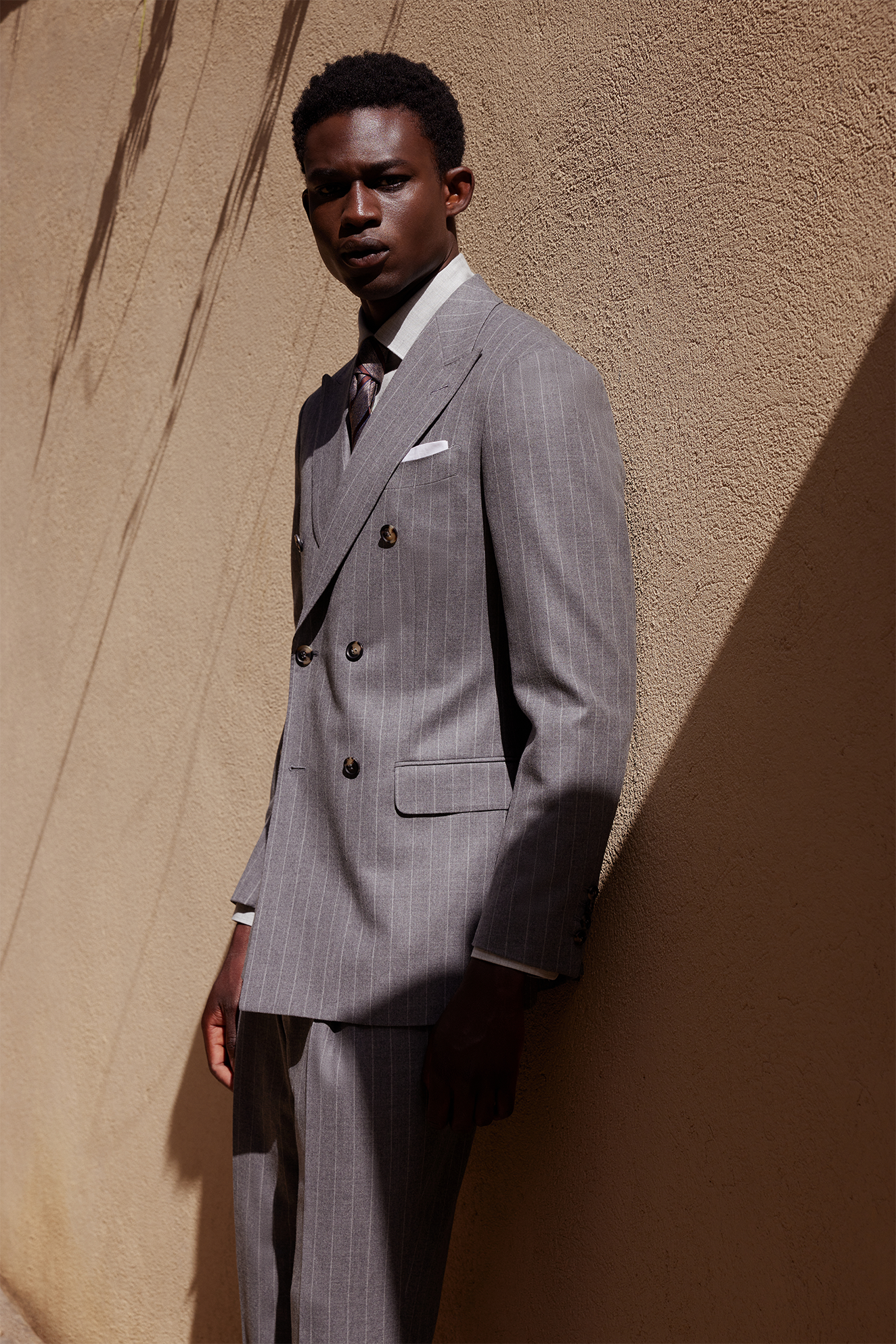 Tailor fitting a suit jacket in the studio